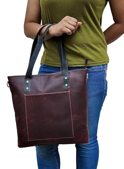 A woman holding a brown pure leather tote handbag with a shoulder sling bag.