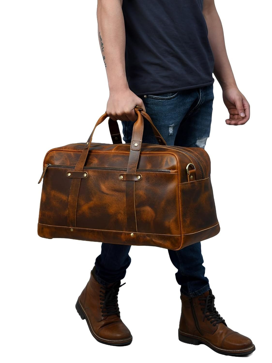 A person holding a large brown leather duffle bag with dual handles.