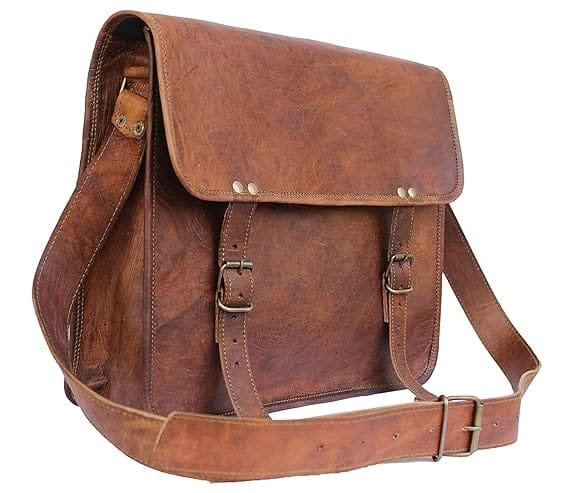 A brown vintage genuine handmade leather laptop & messenger bag with a shoulder strap, buckle closures, and multiple compartments.